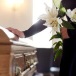 Pre-Planning Funerals: Why It’s Essential And How To Get Started 3 woman with lily flowers and coffin at funeral